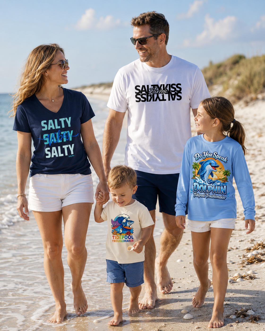 Family of four walking on a beach, wearing Salty Kiss and Tidepool Troublemakers themed t-shirts.